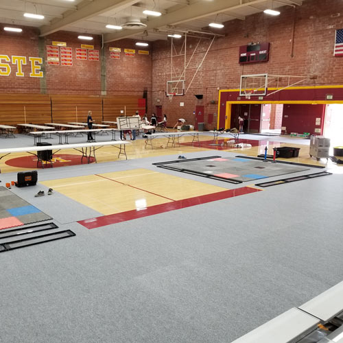 Gym Floor Covering Carpet Tile marauders workers install in school gym