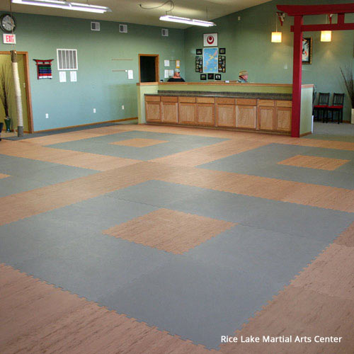 karate studio flooring showing wood grain pattern and gray puzzle mats