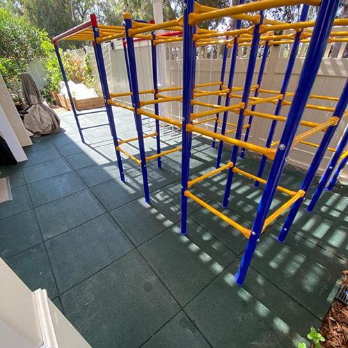Blue Sky Playground Interlocking Tile installed in backyard playground