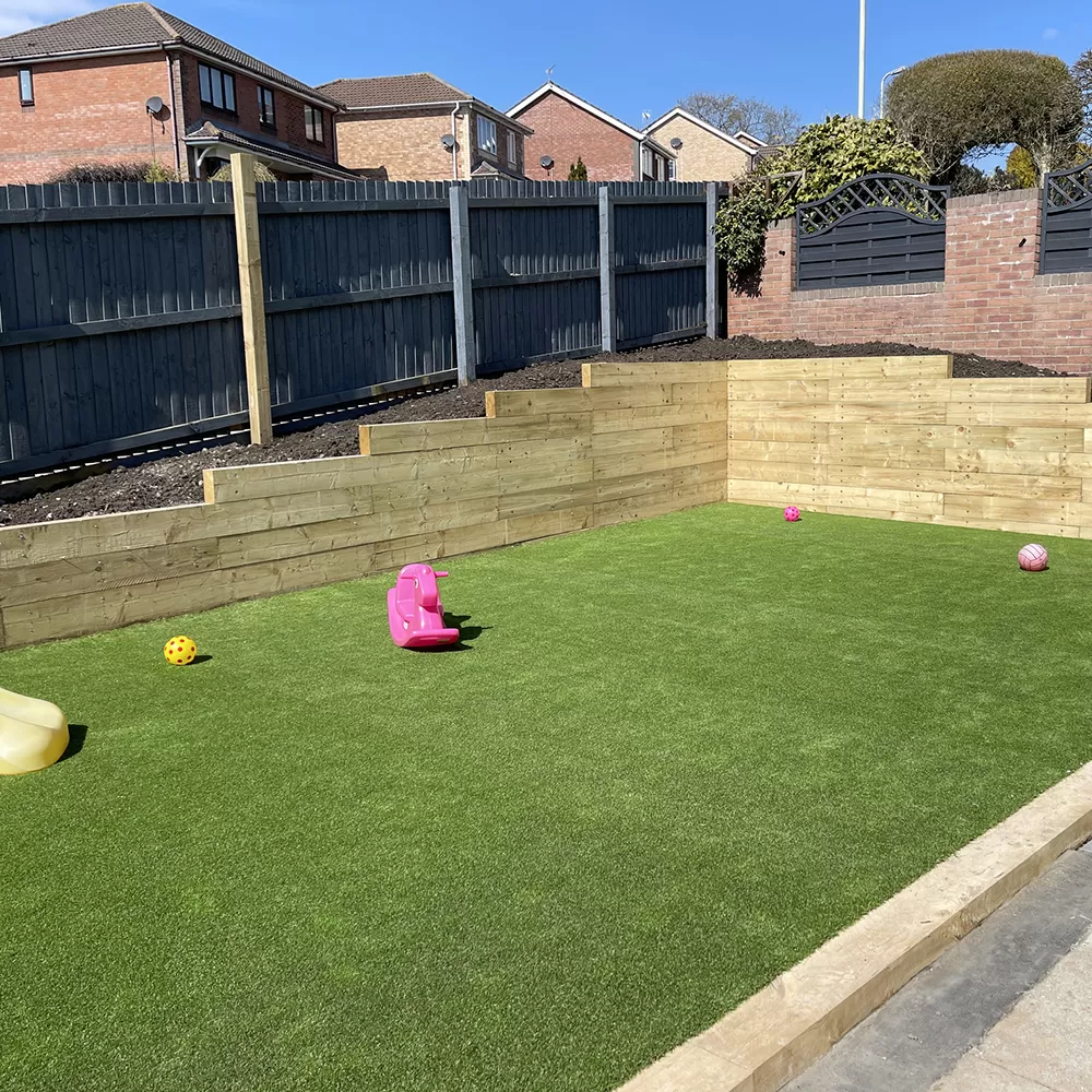 fake grass in back yard with toys