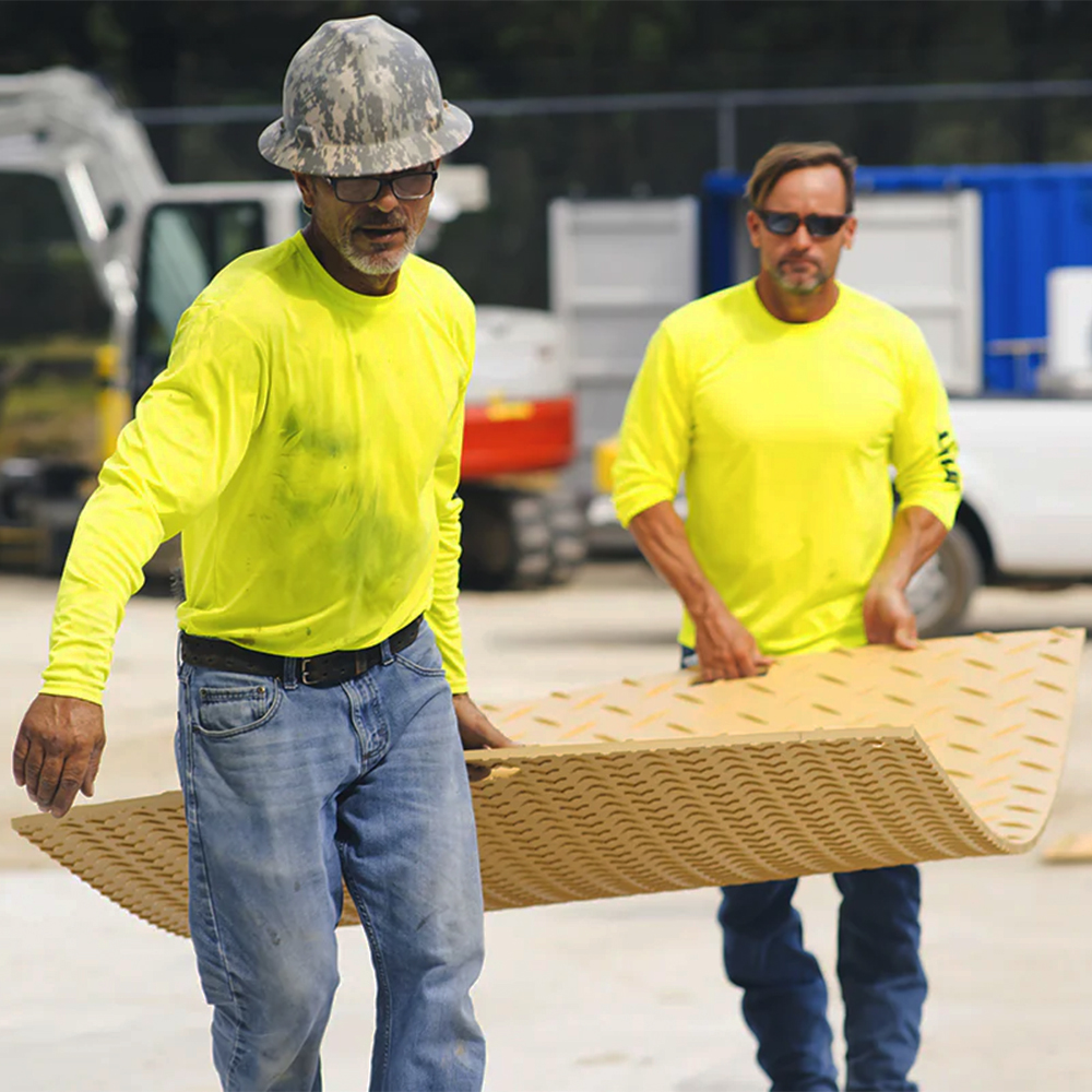 Two workers carrying Blue Gator Ground Protection Diamond Mat 1/2 Inch x 4x8 Ft. in tan