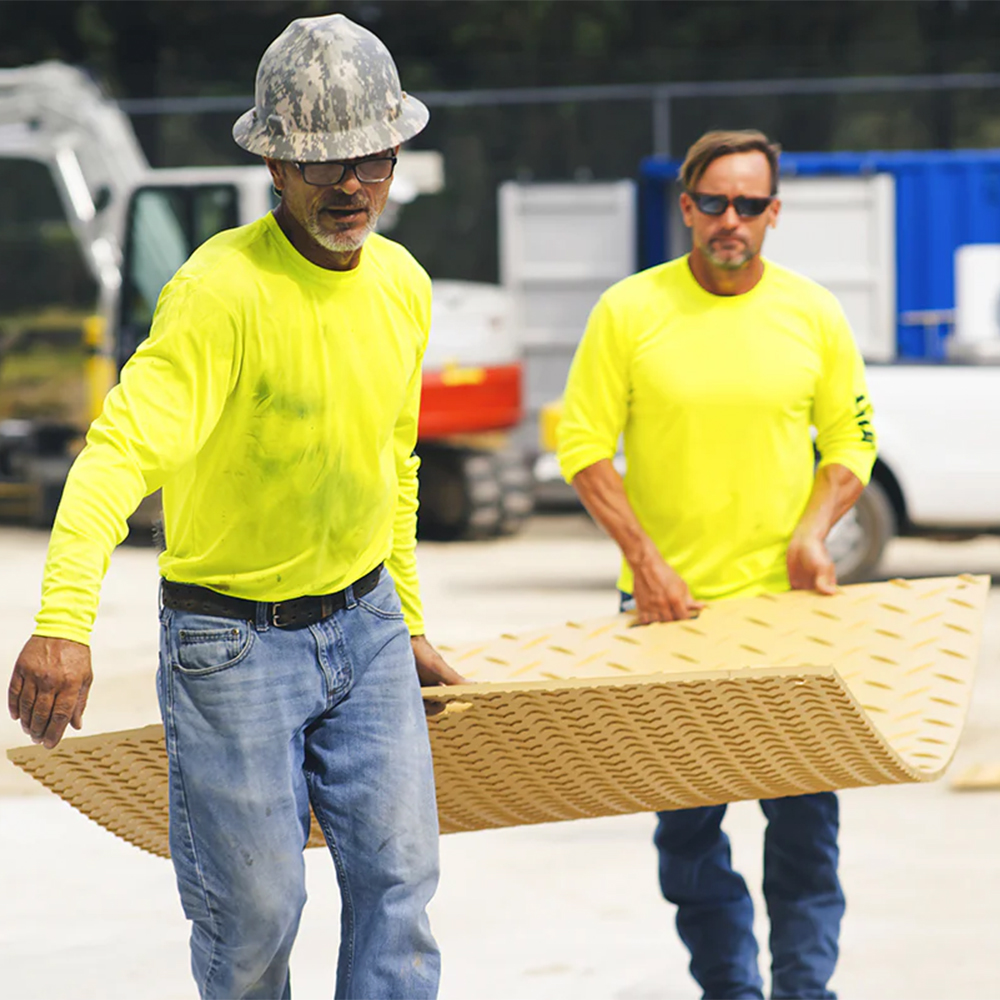 Two guys carrying Blue Gator Lite Ground Protection Diamond Mat Tan 3/8 Inch x 4x8 Ft.