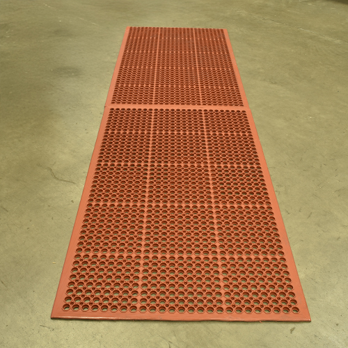 VIP Topdek Senior Red Mat 3x10 Ft. over concrete in a warehouse with long table