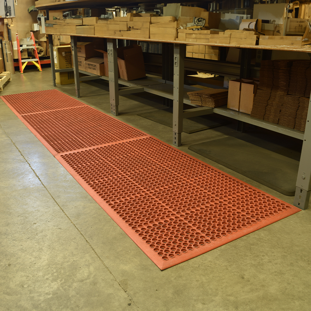 VIP Topdek Senior Red Mat 3 x 14 Feet 8 Inches over concrete in a warehouse with long table