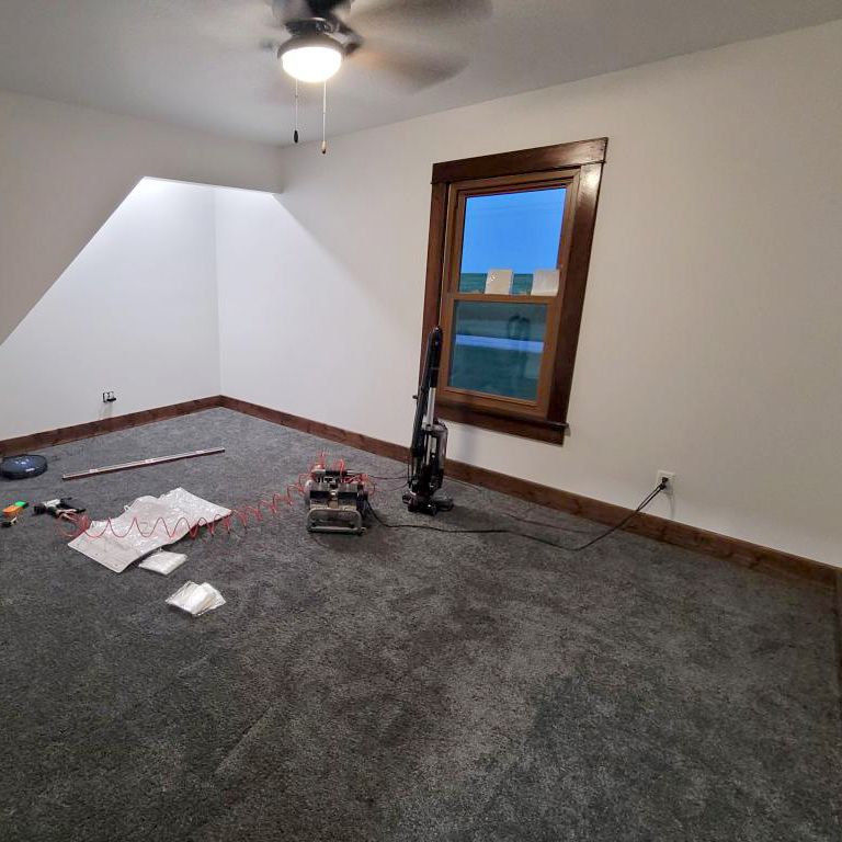 dark gray plush carpet tiles installation in bedroom 