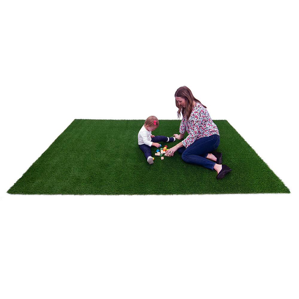 mom with child on green grass carpet rug