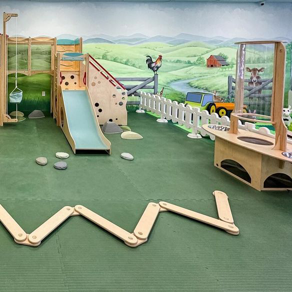 indoor playground inside a cafe with interlocking green foam tiles