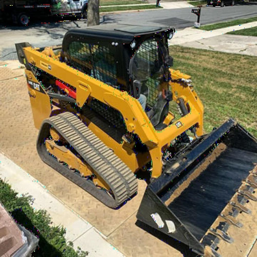 heavy skidsteer on driveway with protection mats