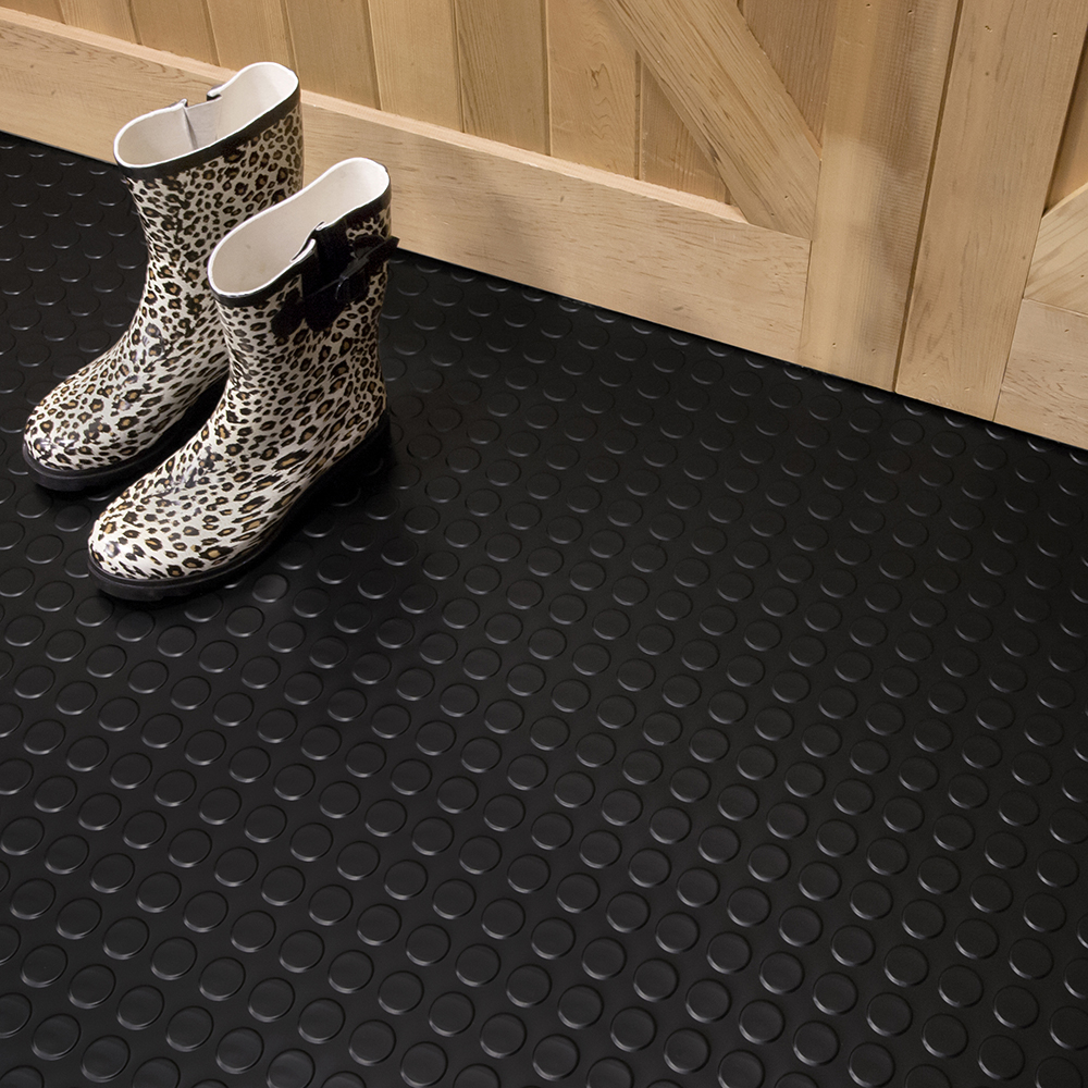 rubber boots on black coin top vinyl flooring in tack room