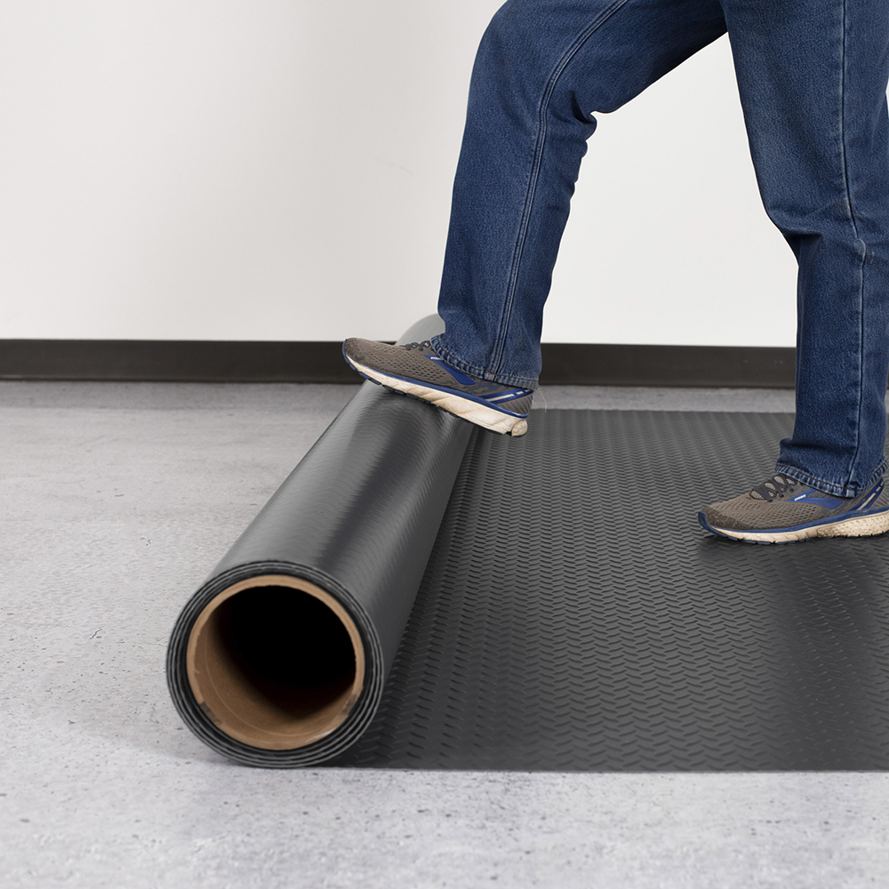 Installing stale gray roll of G-Floor Diamond Tread Garage Floor Roll 75 mil x 7.6x17 Ft. 