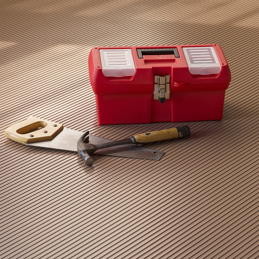 Tools and box on G-Floor Ribbed Tread Garage Floor Roll 55 mil x 8.6x22 Ft. in sandstone