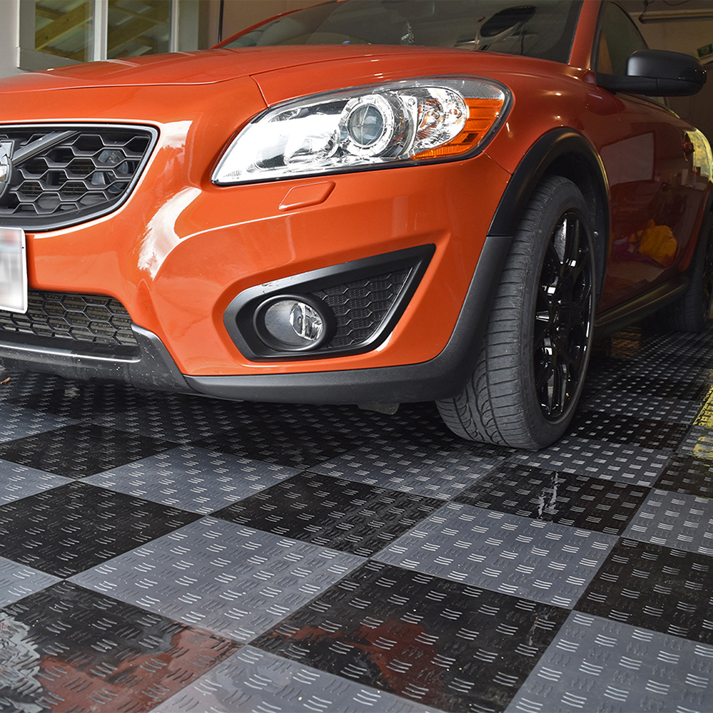 car on black diamond garage tiles