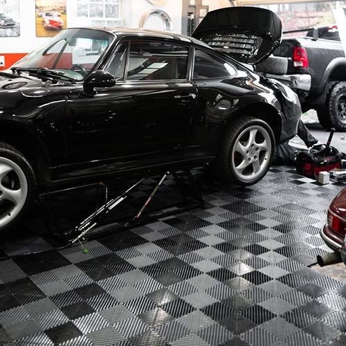 vented garage floor tiles in a workshop garage with porsche