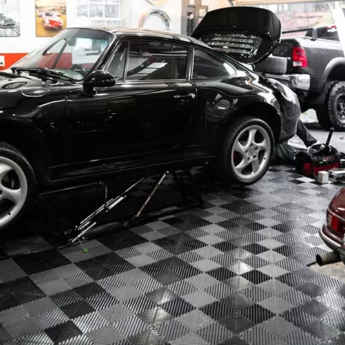 drainage floor tiles in garage with porsche