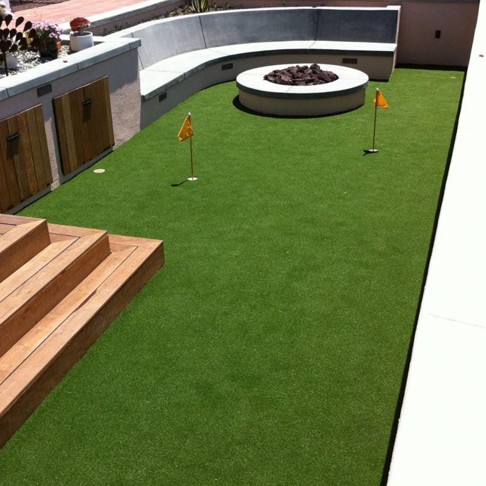 perfect putt turf installed on rooftop putting green with bench and patio fire ring