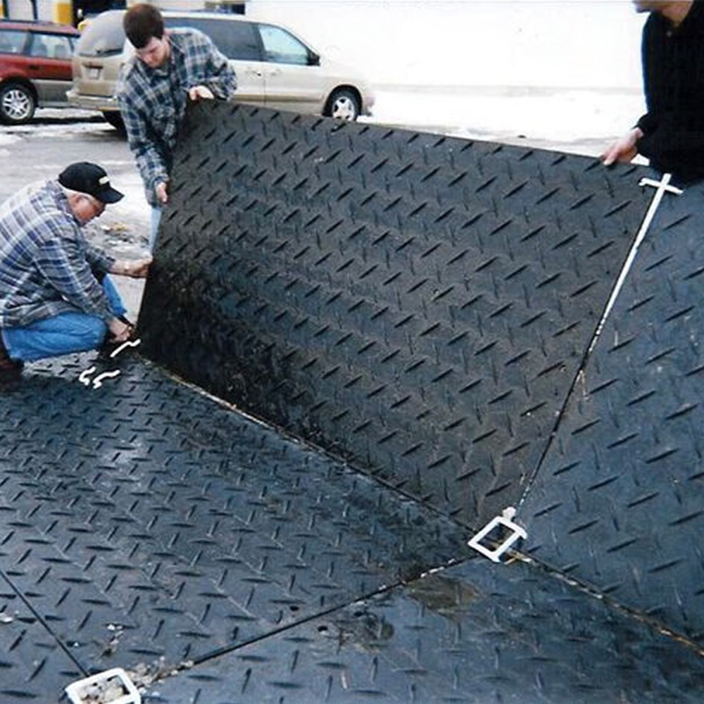 people installing links on ground protection mats to connect the mats together