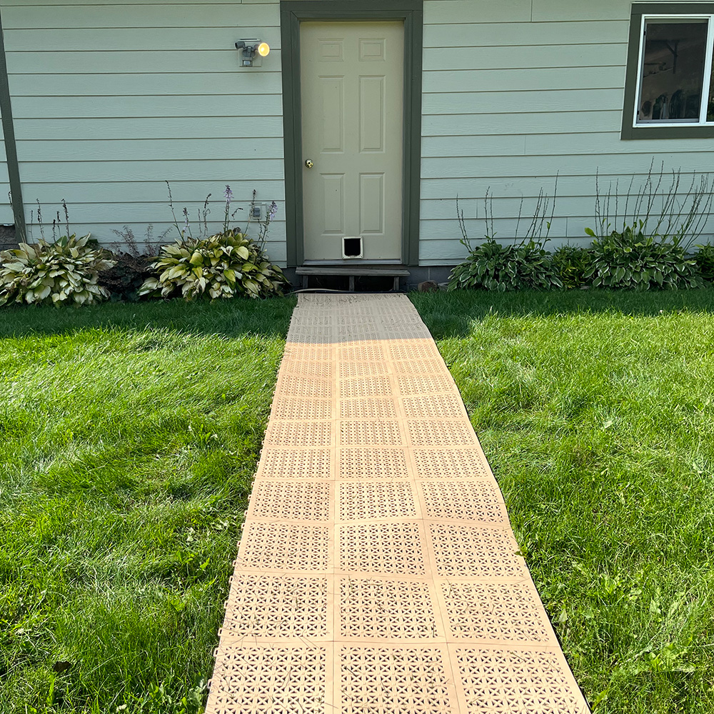 temporary outdoor staylock tiles walkway over grass in backyard