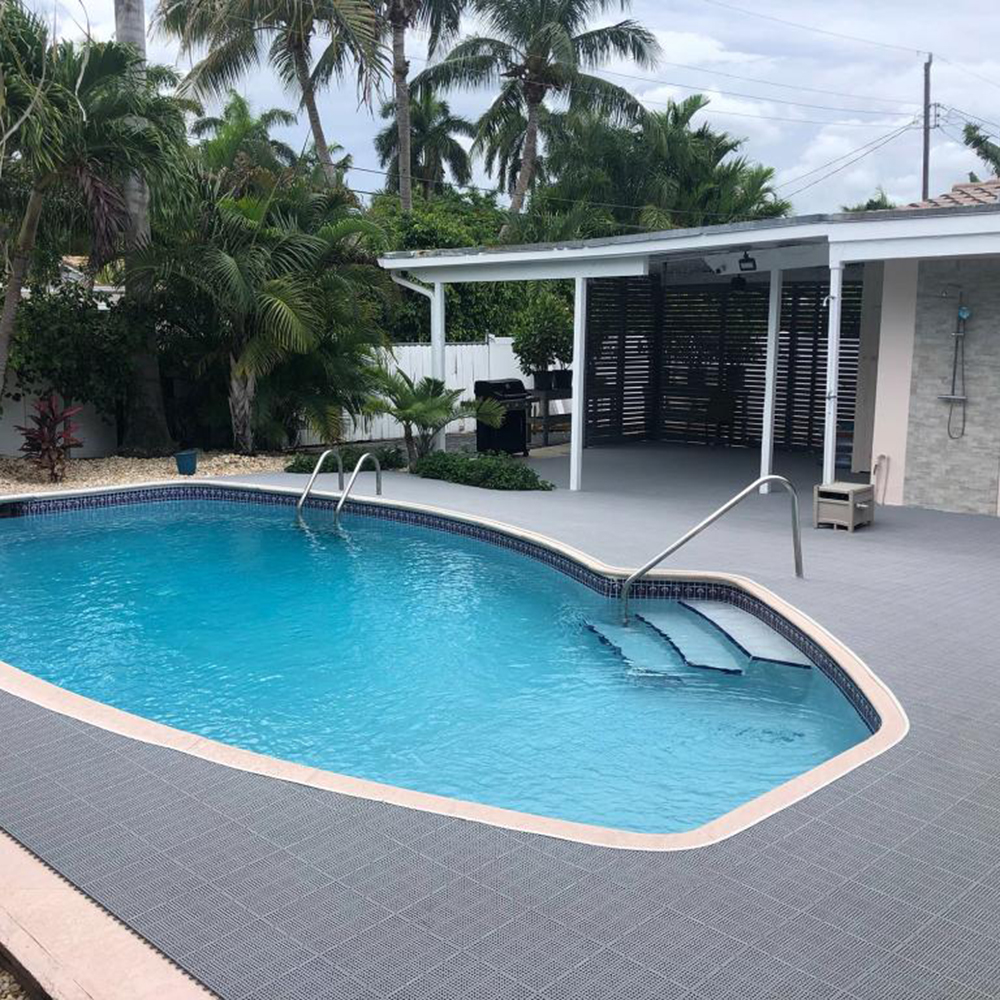 grey perforated tiles installed on outdoor pool deck in backyard