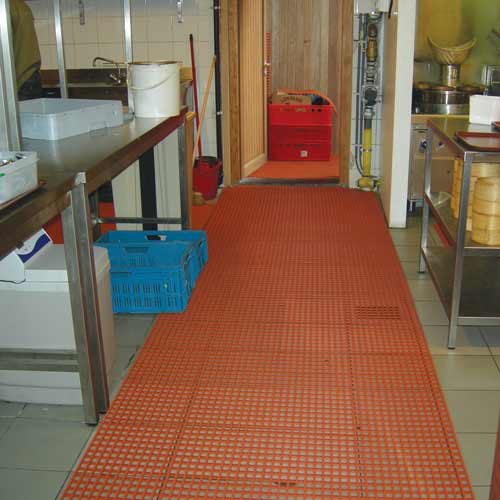 red open grid mats on commercial kitchen floor