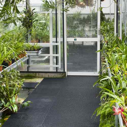 black greenhouse floor mats in commercial greenhouse