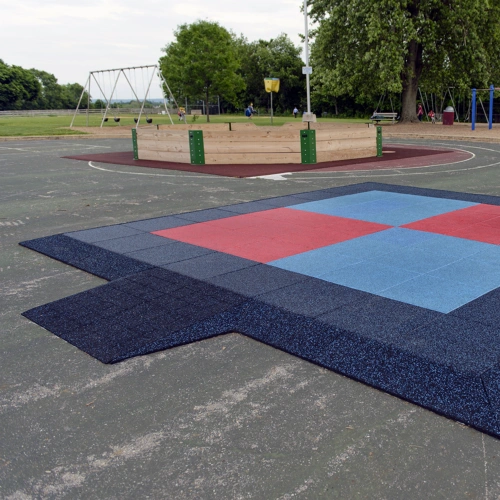 Playground tiles installed with ramped borders and ADA wheelchair access ramp