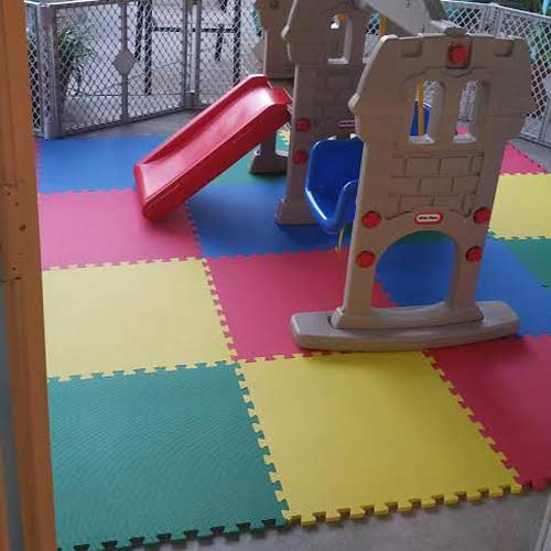 small outdoor play area with interlocking foam matting