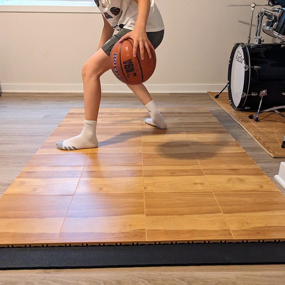 basketball court tiles installed in home with boy dribbling ball