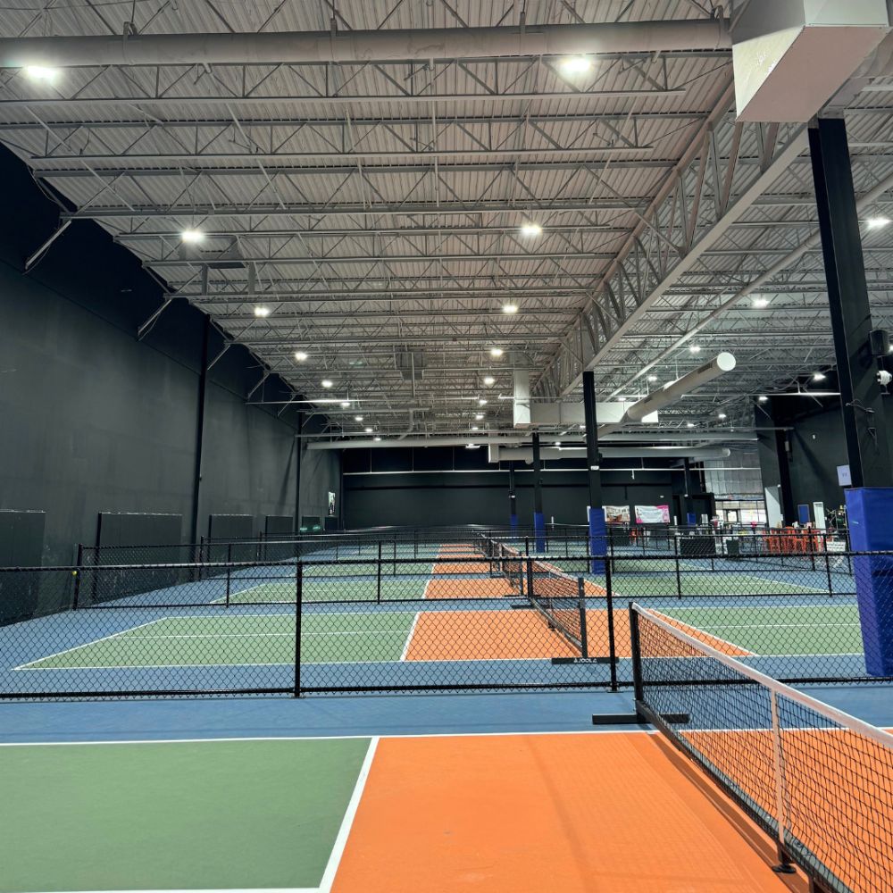 indoor pickleball court with wall pads