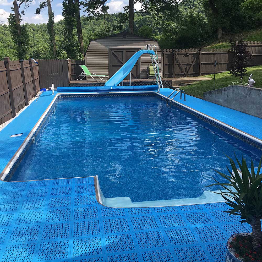 blue perforated tiles installed around home pool deck