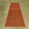 VIP Topdek Senior Red Mat 3x10 Ft. over concrete in a warehouse with long table