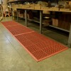 VIP Topdek Senior Red Mat 3 x 14 Feet 8 Inches over concrete in a warehouse with long table