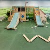 indoor playground for kids inside a cafe restaurant with green floor mats