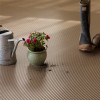 Flowers, boots and water can on G-Floor Ribbed Tread Garage Floor Roll 55 mil x 8.6x22 Ft. in sandstone