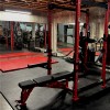 home gym in basement with foam floor mats under gym rack