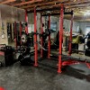 home gym in basement with foam floor mats under gym equipment
