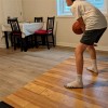 indoor basketball court tiles in living room with boy dribbling ball