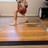 basketball court tiles installed in home with boy dribbling ball