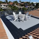 rooftop patio with chairs and firepit using staylock perforated outdoor deck tiles