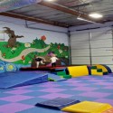 kids playing on foam tiles in gymnastics center
