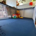 blue kids foam floor mats in playpen with toys