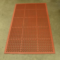 VIP Topdek Senior Red Mat 3x5 Ft. over concrete in a warehouse with long table