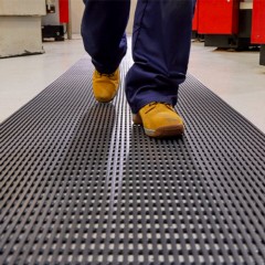 close up of person walking on heronair matting in manufacturing facilitiy