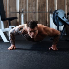 Man Doing Pushups on Rolled Rubber Flooring