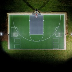 VersaCourt Boost Outdoor Court Tile 1/2 Inch x 1x1 Ft.in emerald greena and graphite aerial view with lights