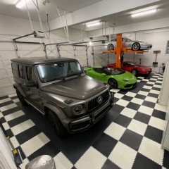 large garage with garage floor tiles in checkerboard black and white pattern